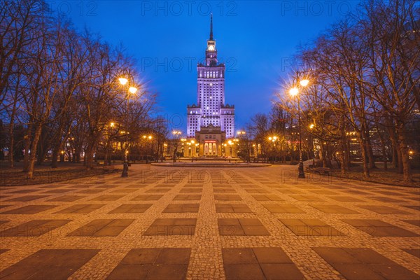 Poland, Masovia, Warsaw, Illuminated high rise building at town square