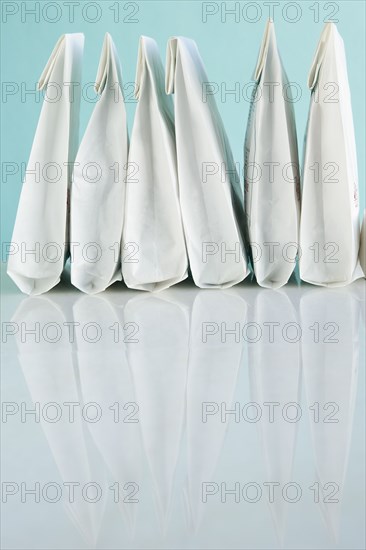 Row of white prescription bags