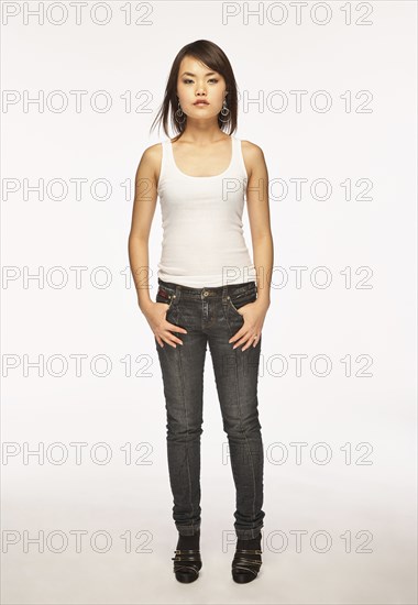 Studio portrait of woman in white tank top