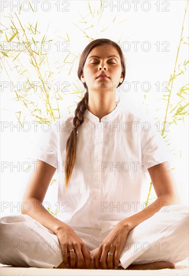 Woman meditating with eyes closed