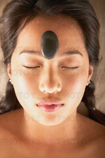 Woman with rock on forehead