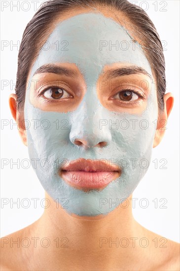 Studio portrait of woman with blue facial mask