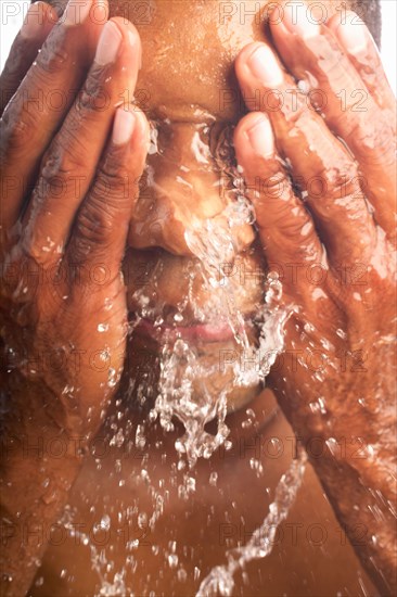 Close-up of man washing face