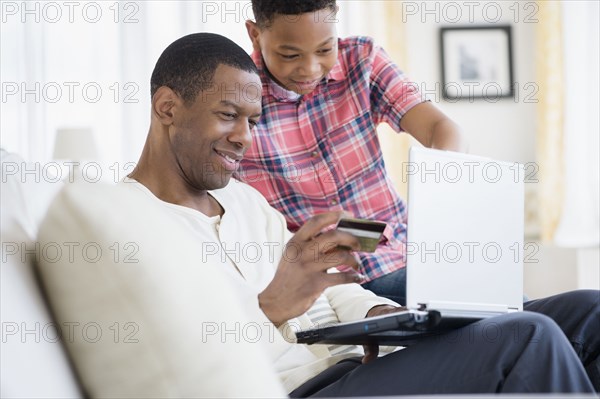 Father and son shopping online