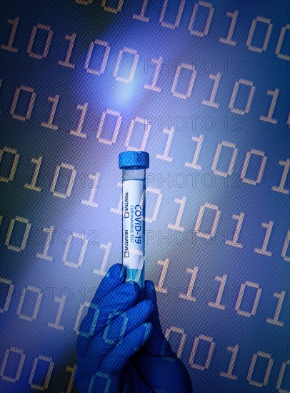 Gloved hand holding a Covid-19 test tube and binary code