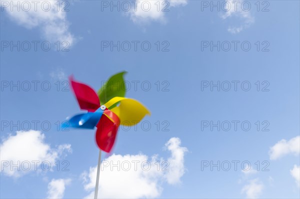 Colorful pinwheel blowing in wind against sky