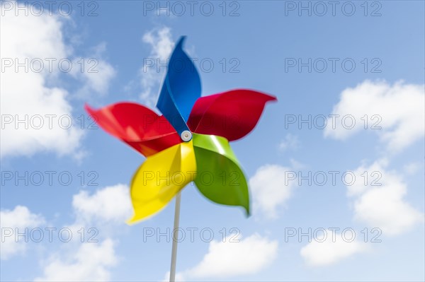 Colorful pinwheel blowing in wind against sky