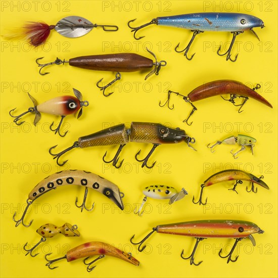 Retro fishing lures against yellow background