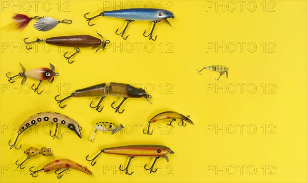 Retro fishing lures against yellow background