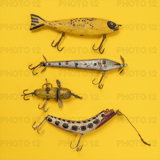 Retro fishing lures against yellow background