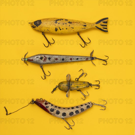 Retro fishing lures against yellow background