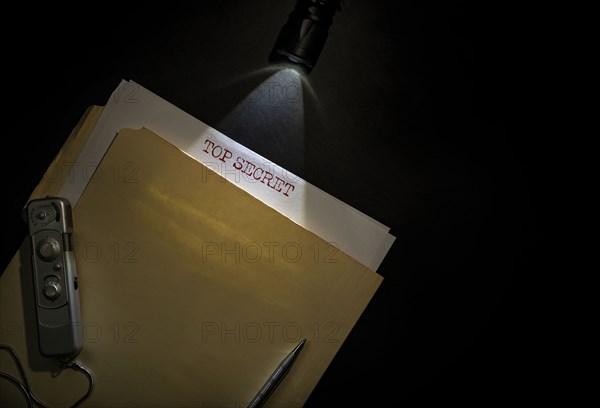 Overhead view of top secret documents on desk top