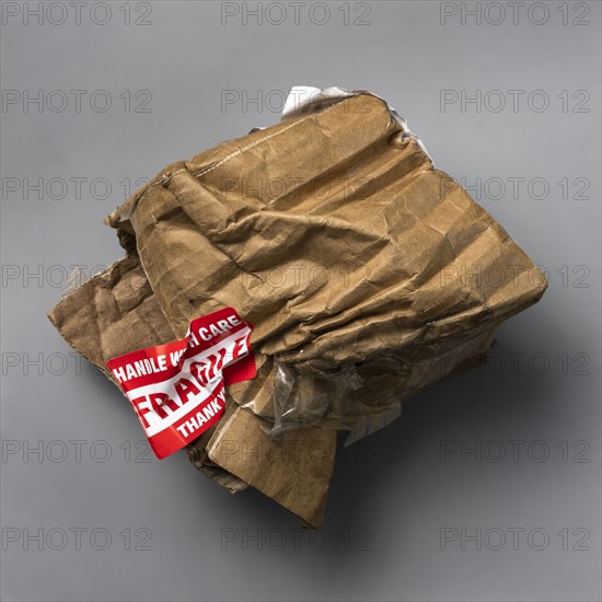 Fragile handle with care sticker on crushed package