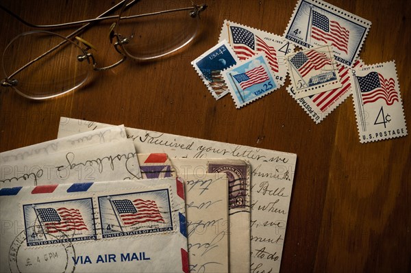 Letters with American flag postage stamps on table
