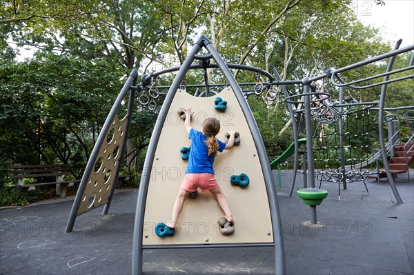 Rear view of girl on climbing wall