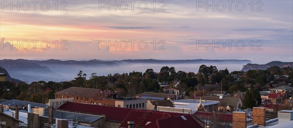 Townscape and mountains at sunset