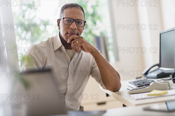 Portrait of smiling mature man working in home office