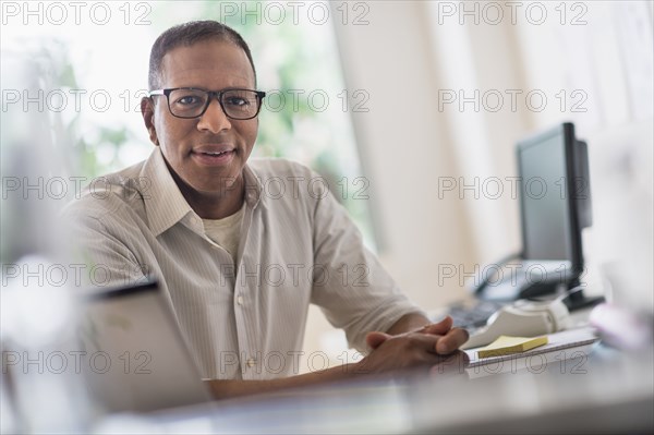 Portrait of smiling mature man working in home office