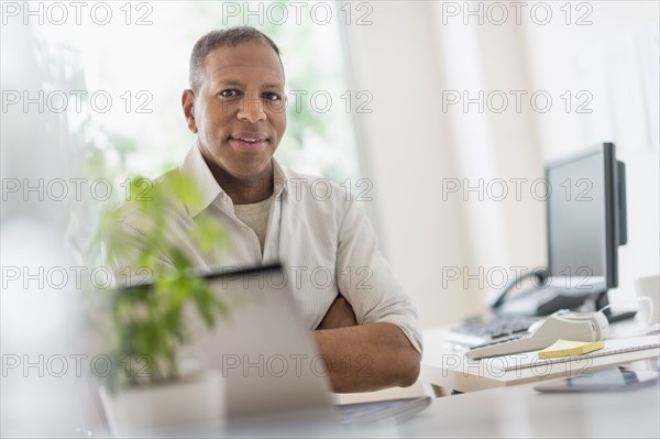 Portrait of smiling mature man working in home office