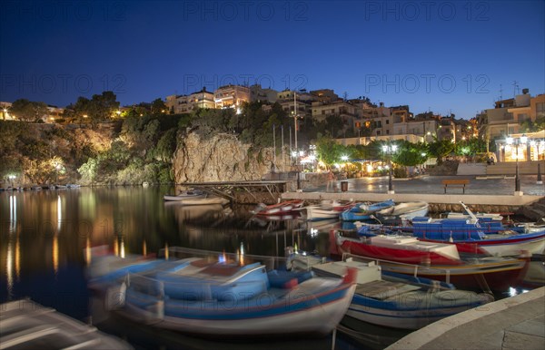 Boats in harbor and village on cliffs