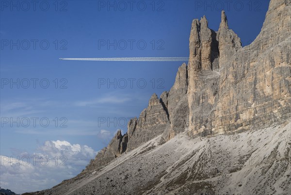 Commercial jet flying over Dolomites