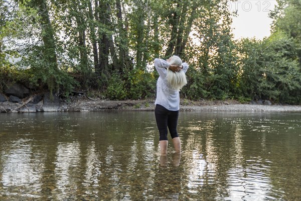 Senior woman standing in river