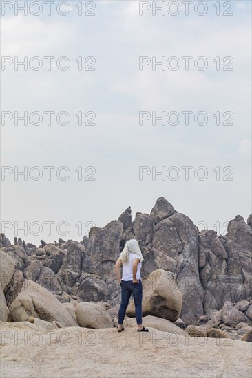 Woman looking at Alabama Hills rock formations
