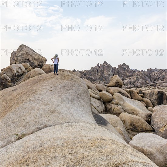 Woman looking at Alabama Hills