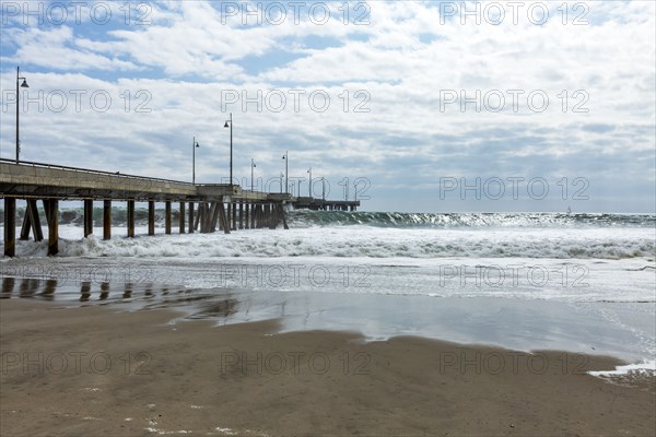 Waves cresting under pier