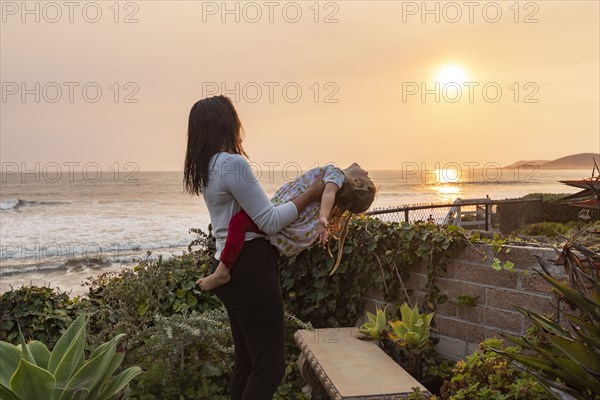 Mother holding daughter