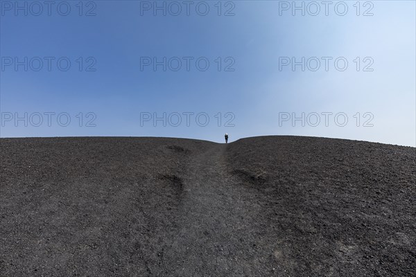 Woman hiking in cinder cone at Craters of the Moon National Monument