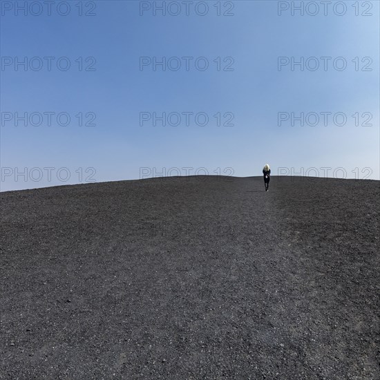 Woman hiking in cinder cone at Craters of the Moon National Monument