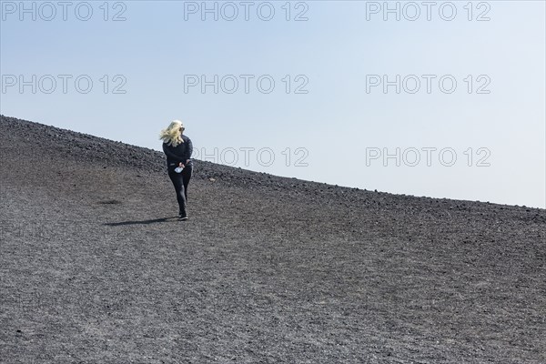 Woman hiking in cinder cone at Craters of the Moon National Monument