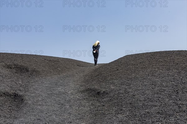 Woman hiking in cinder cone at Craters of the Moon National Monument