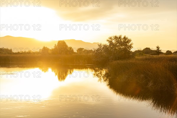 Sunrise reflected in spring creek near Sun Valley