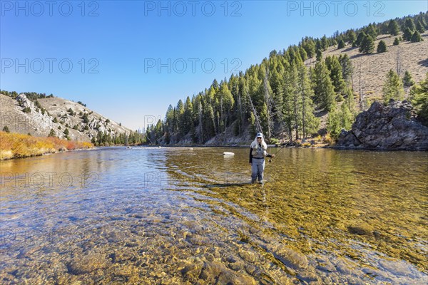 Woman fly-fishing in Salmon River