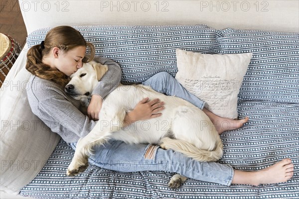 Girl embracing English Cream Golden Retriever