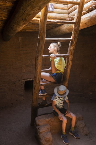 Boy and girl exploring Native American kiva