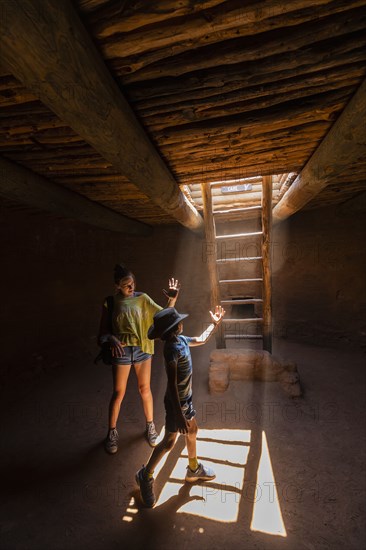 Boy and girl exploring Native American kiva