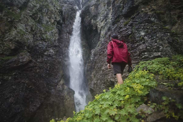 Hiker standing near waterfall