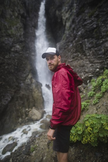 Hiker standing near waterfall