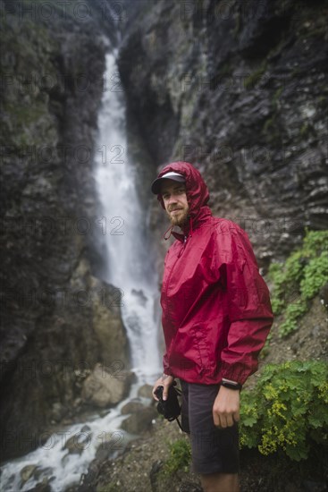 Hiker standing near waterfall