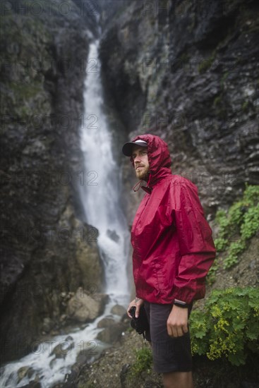 Hiker standing near waterfall