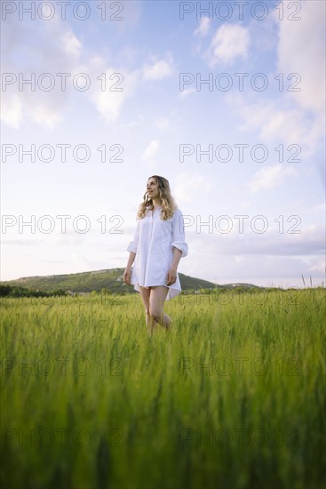 Young woman standing in agricultural field