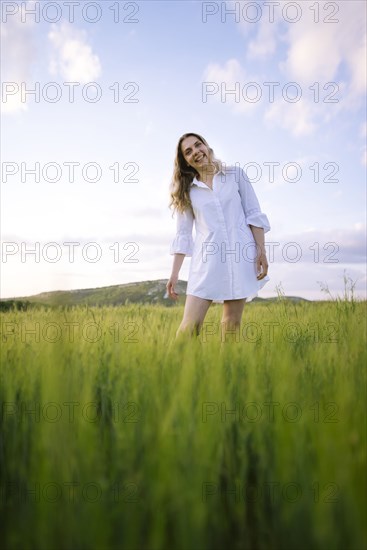 Young woman standing in agricultural field