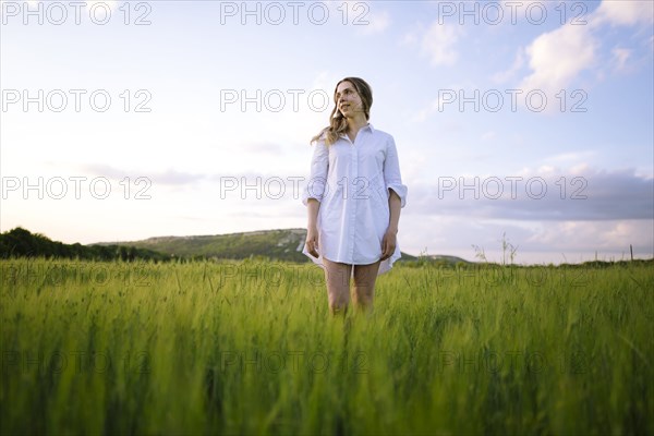 Young woman standing in agricultural field