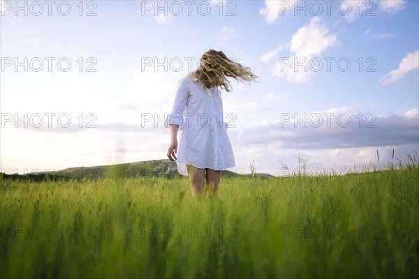 Young woman standing in agricultural field