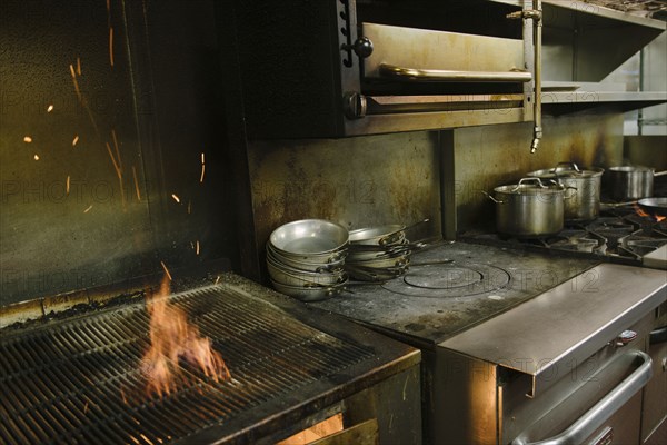Flaming grill in restaurant kitchen