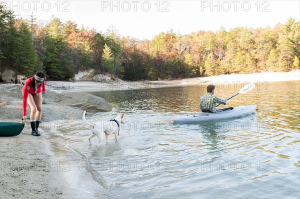 Couple kayaking in remote lake