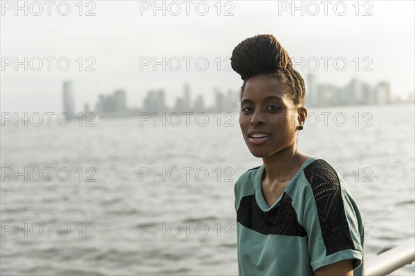 Portrait of African American woman with braids at waterfront
